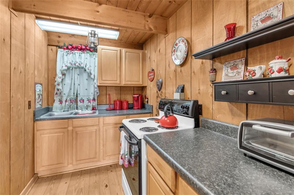 231 Lookout Ridge Road Cleveland, GA 30528 - Photo 11 of 20 a kitchen with stainless steel appliances granite countertop a sink dishwasher stove and cabinets