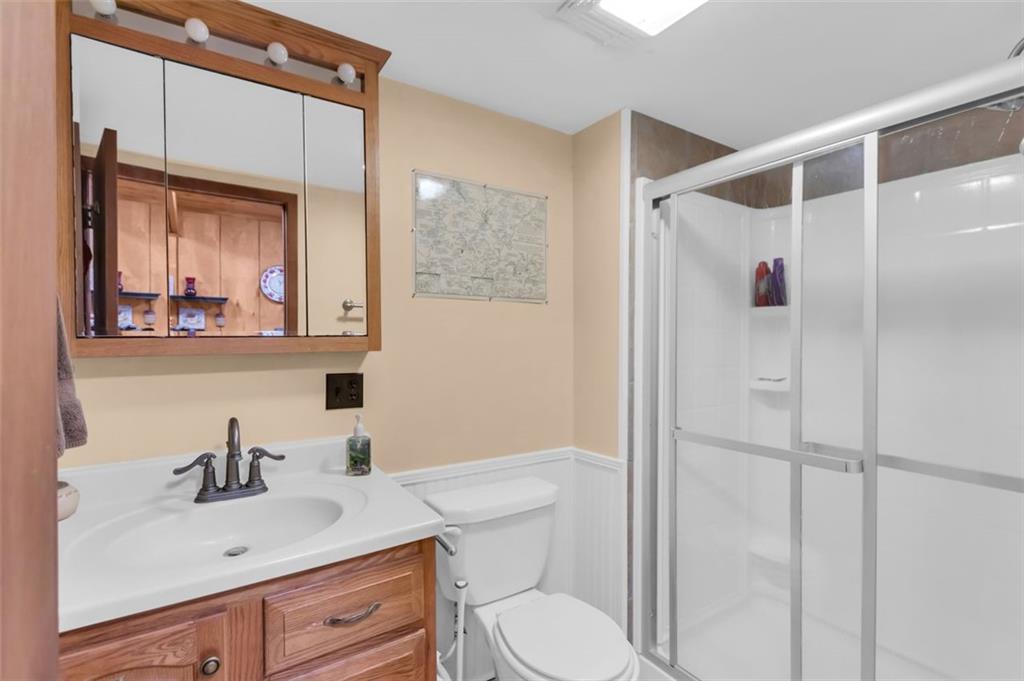 231 Lookout Ridge Road Cleveland, GA 30528 - Photo 12 of 20 a bathroom with a sink vanity mirror and toilet