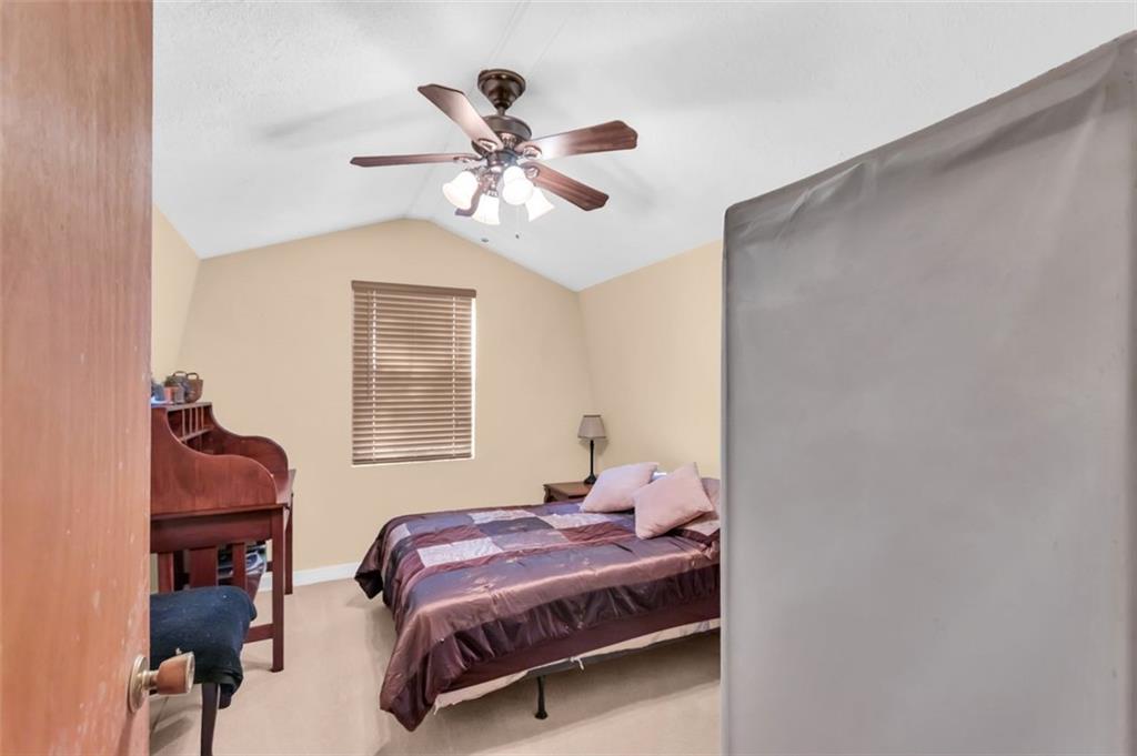 231 Lookout Ridge Road Cleveland, GA 30528 - Photo 13 of 20 a bedroom with a bed and a chandelier fan