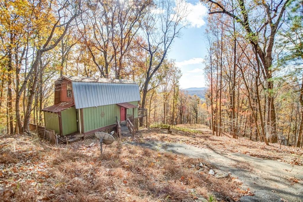 231 Lookout Ridge Road Cleveland, GA 30528 - Photo 2 of 20 a view of backyard with wooden fence and large trees