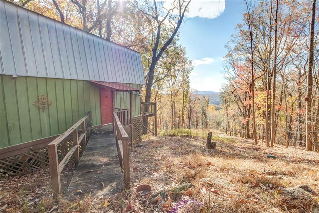 231 Lookout Ridge Road Cleveland, GA 30528 - Photo 4 of 20 a backyard of a house with large trees and wooden fence