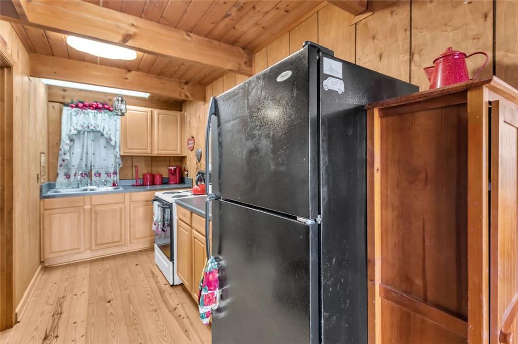 231 Lookout Ridge Road Cleveland, GA 30528 - Photo 10 of 20 a kitchen with a refrigerator and white cabinets