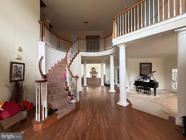 a view of a livingroom with wooden floor and furniture