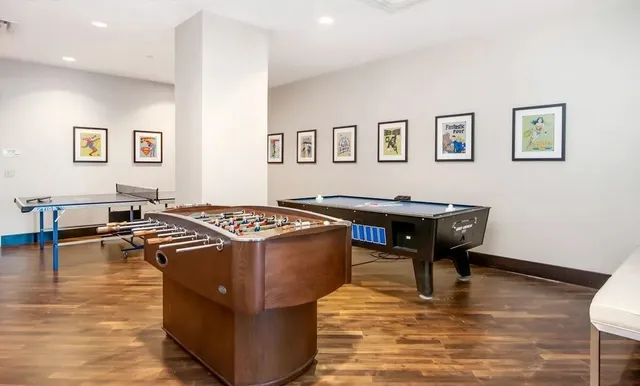 a room with pool table and windows