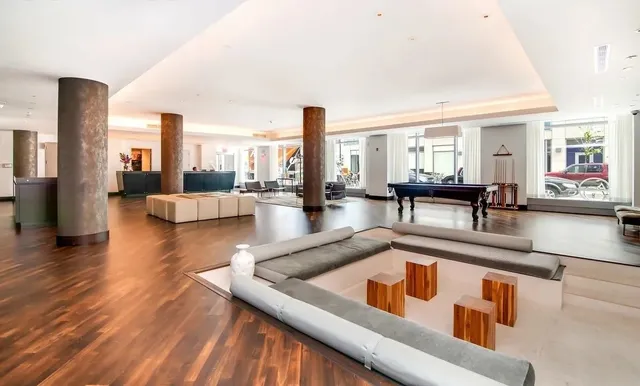 a living room with dining table and a wooden floor