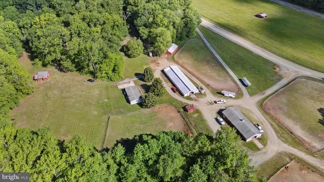 an aerial view of a house with a yard and lake