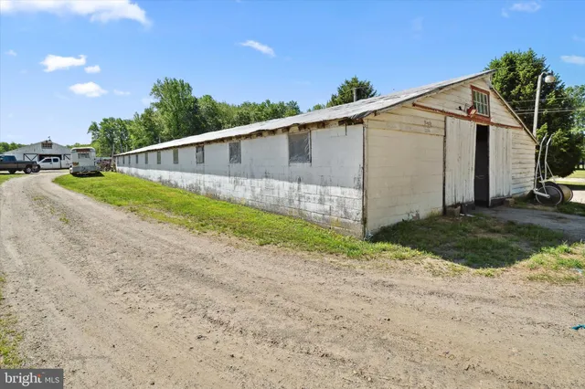 a view of a kitchen with wooden floor and electronic appliances