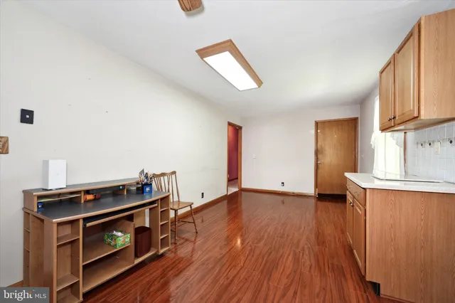 a big room with windows and a dresser