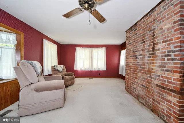 an empty room with closet and a chandelier fan
