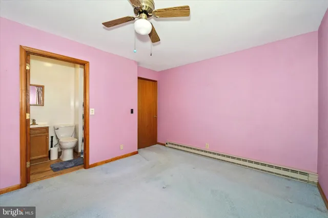 a white toilet sitting next to a shower curtain