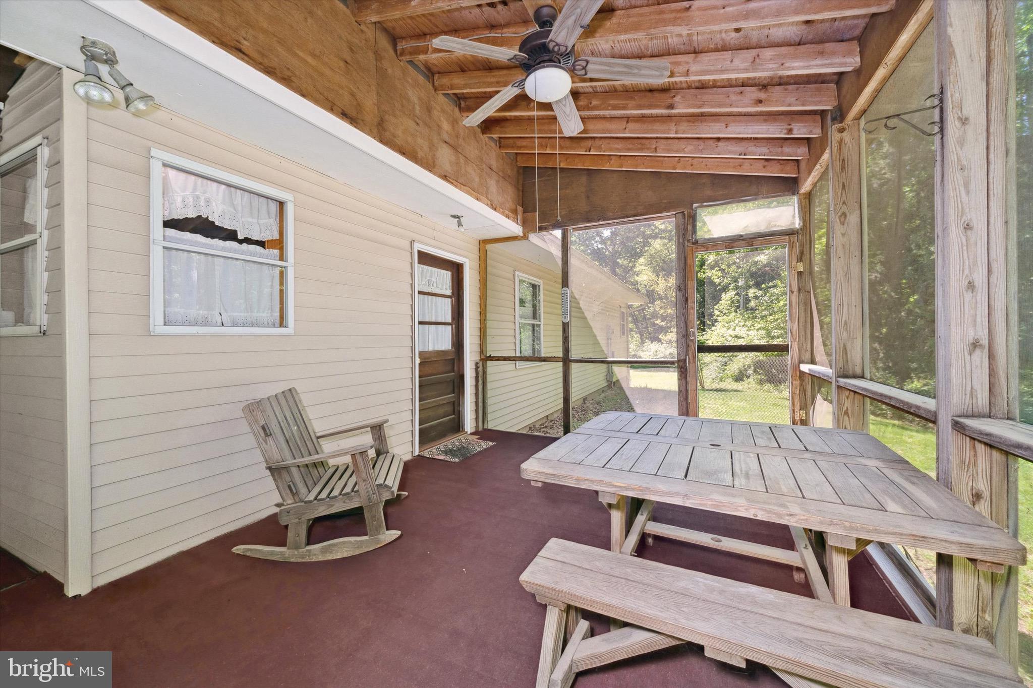 197-199 Pine Tree Road Townsend, DE 19734 - Photo 50 of 62 a living room with furniture a flat screen tv and a floor to ceiling window