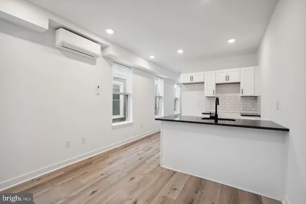 a view of a kitchen with wooden floor