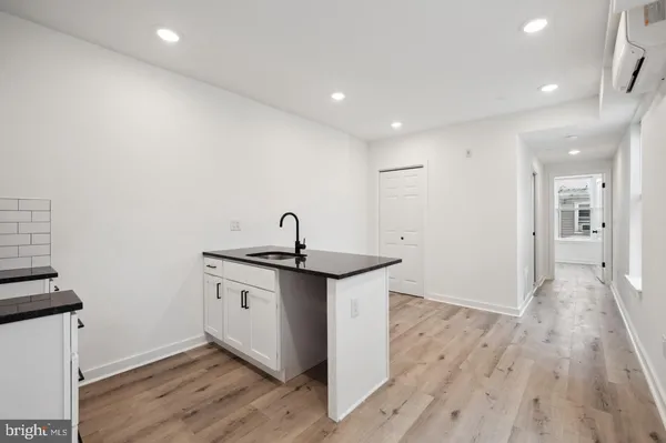 a kitchen with stainless steel appliances granite countertop a sink stove and wooden floor