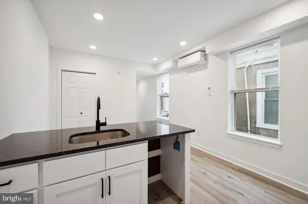 a kitchen with a sink appliances and a window