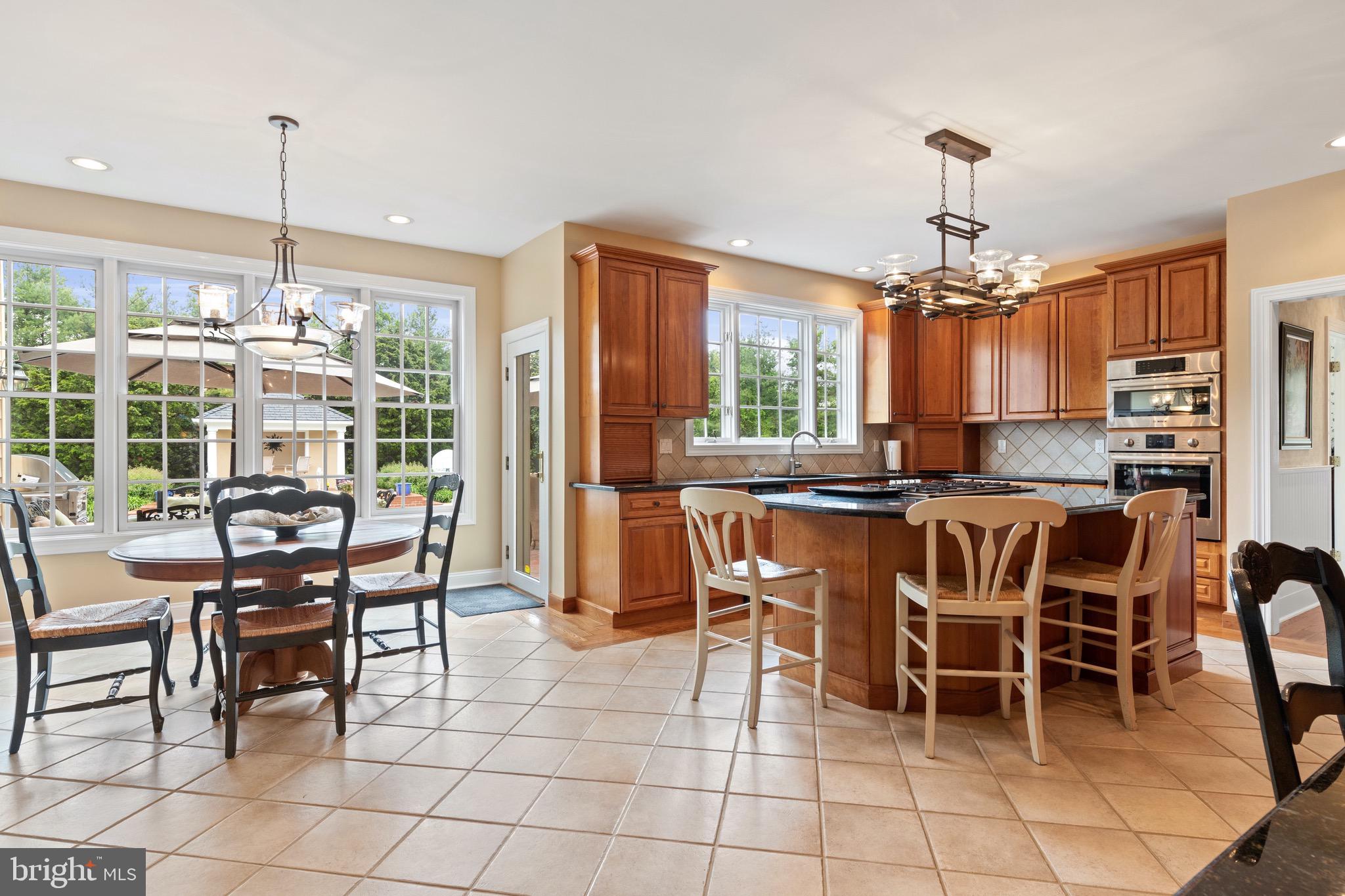 1860 Covered Bridge Road Malvern, PA 19355 - Photo 26 of 59 a dining area with granite countertop a table chairs and a chandelier