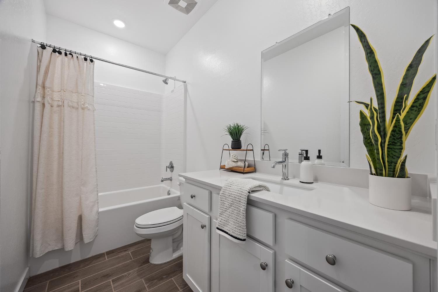 2601 Auburn Street Lemoore, CA 93245 - Photo 13 of 29 a bathroom with a sink a toilet and shower