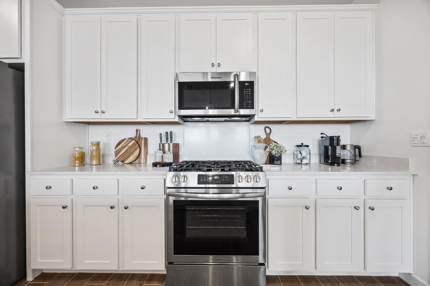 2601 Auburn Street Lemoore, CA 93245 - Photo 19 of 29 a kitchen with white cabinets and stainless steel appliances