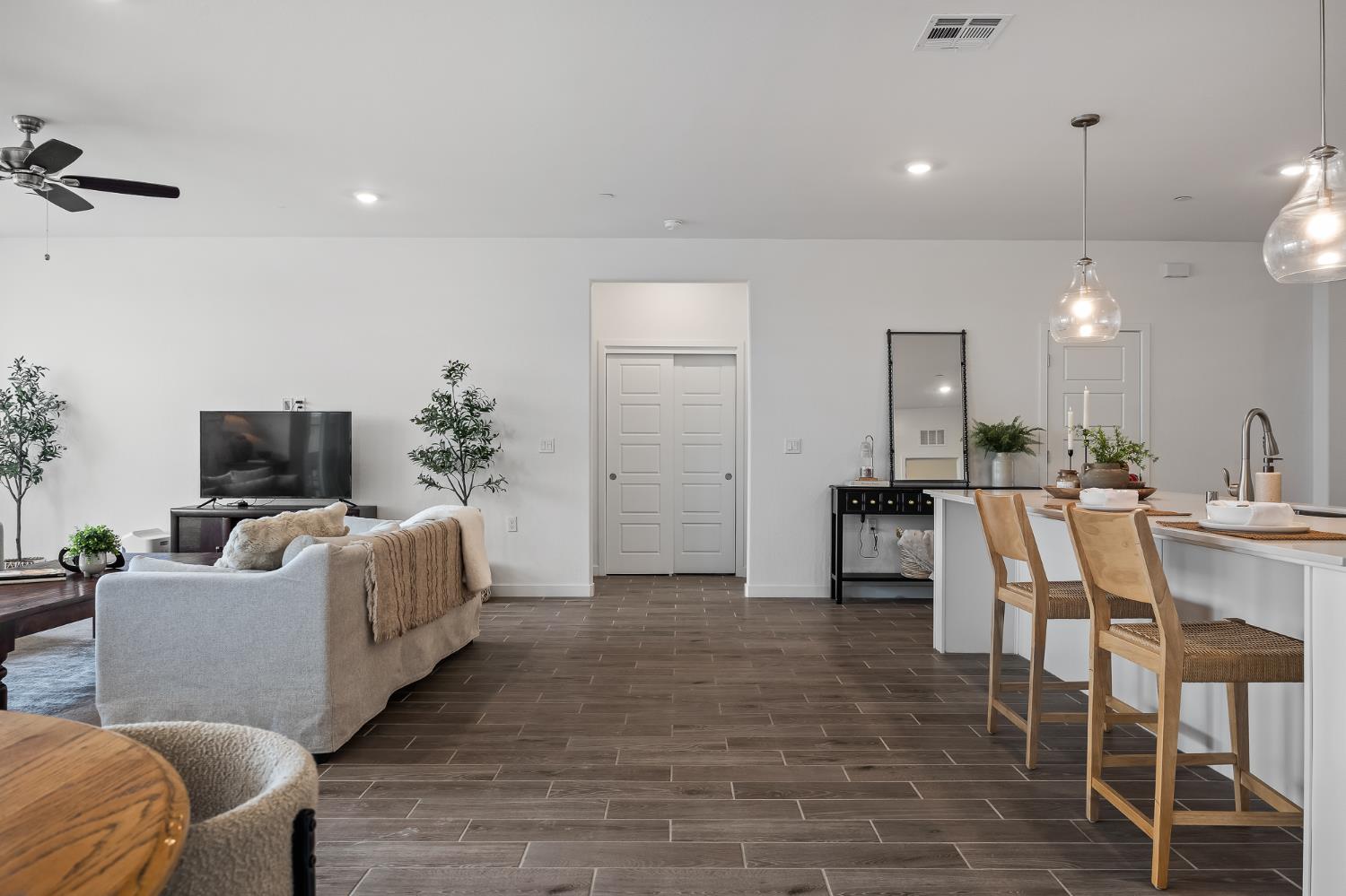 2601 Auburn Street Lemoore, CA 93245 - Photo 24 of 29 a living room with furniture a flat screen tv and kitchen view