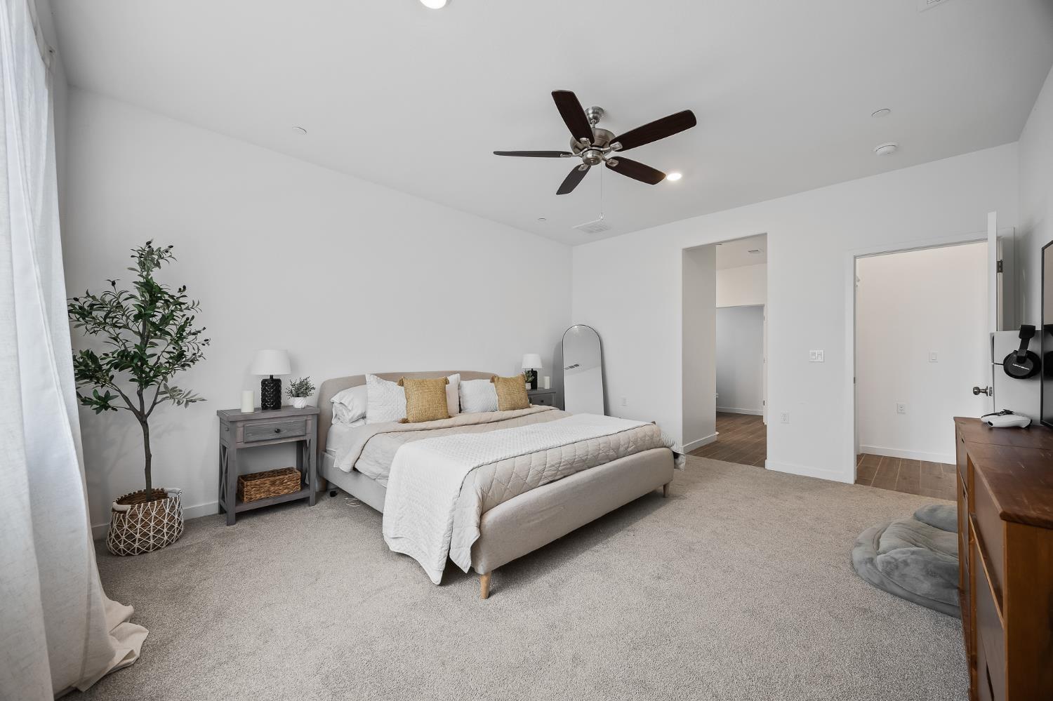 2601 Auburn Street Lemoore, CA 93245 - Photo 3 of 29 a spacious bedroom with a bed and a potted plant