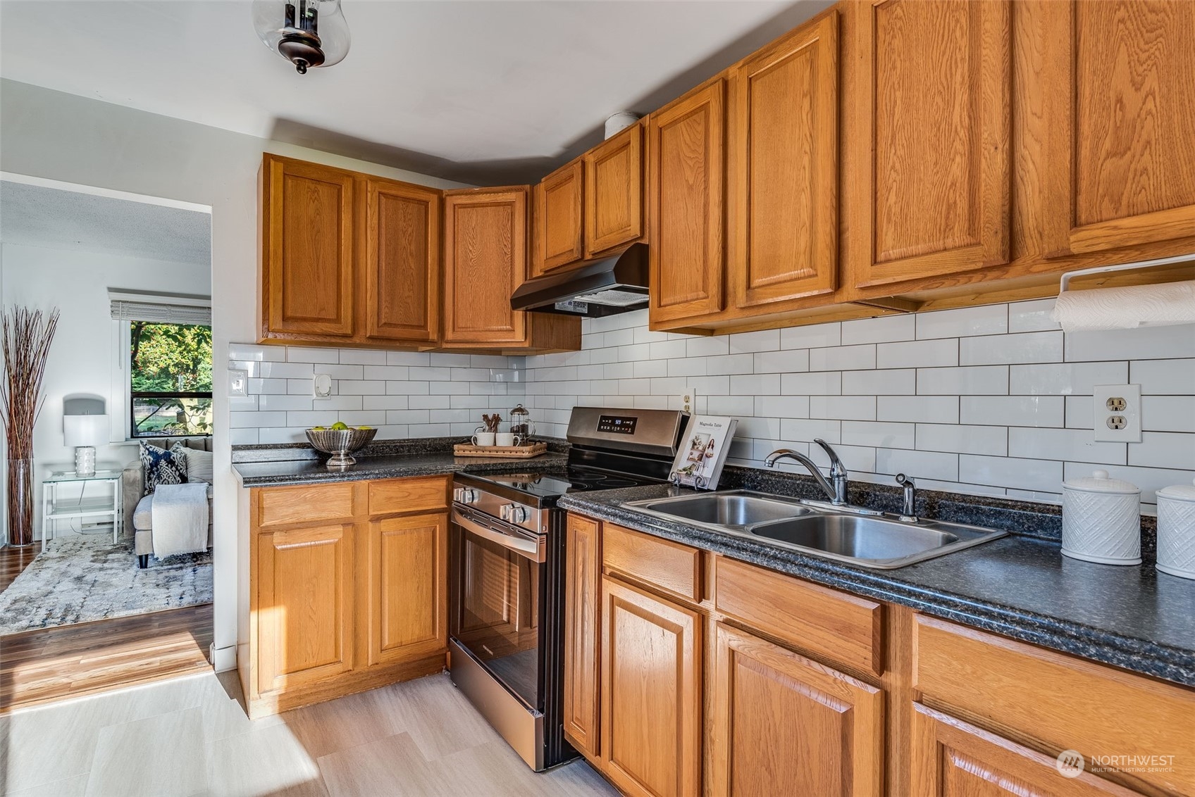 3617 Northeast 12th Street Renton, WA 98056 - Photo 11 of 33 a kitchen with stainless steel appliances granite countertop a sink stove and cabinets