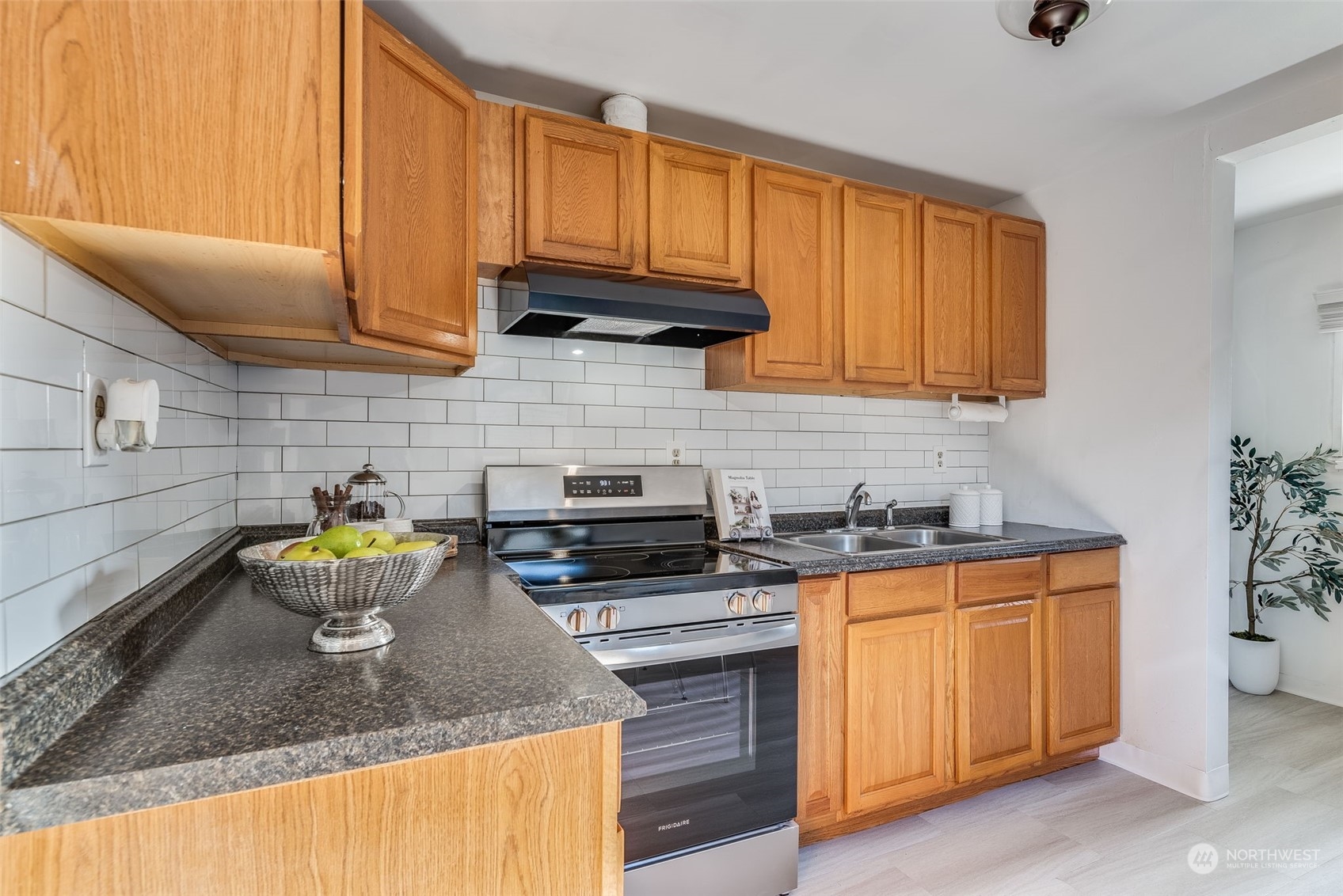 3617 Northeast 12th Street Renton, WA 98056 - Photo 12 of 33 a kitchen with a sink a stove and cabinets