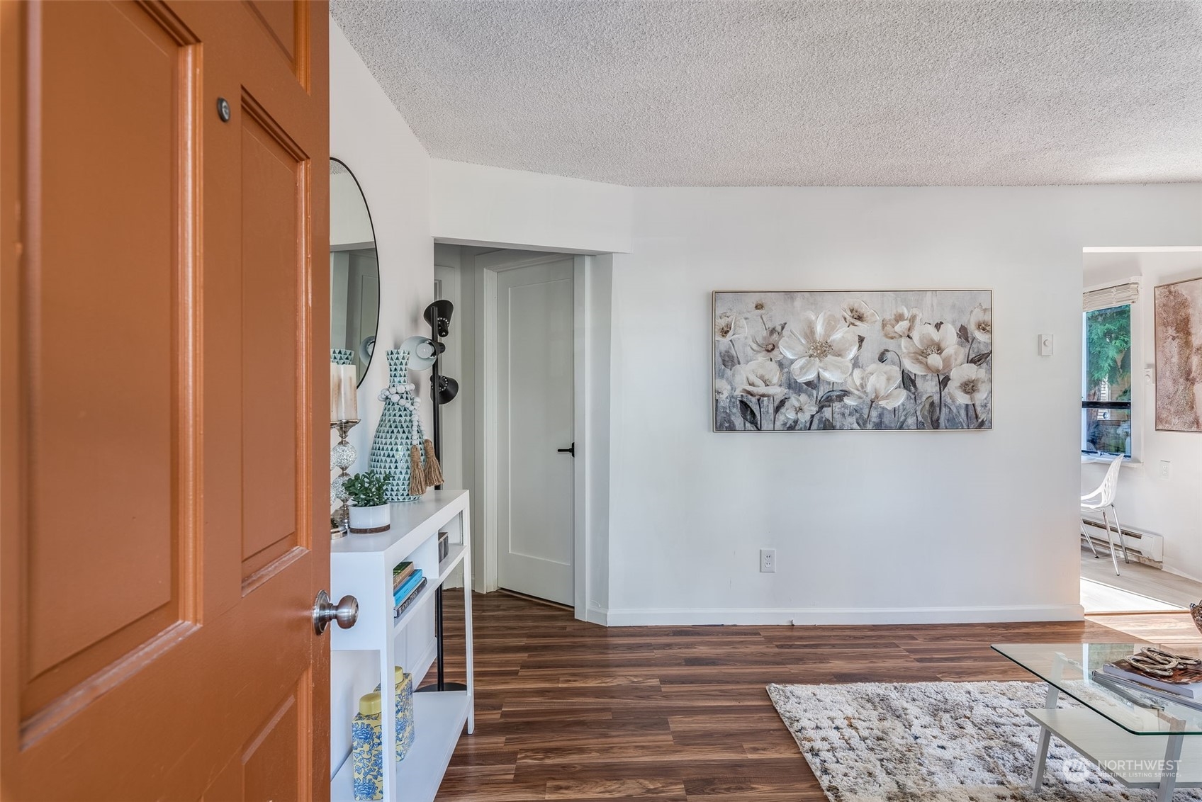 3617 Northeast 12th Street Renton, WA 98056 - Photo 5 of 33 a view of a hallway with wooden floor and a livingroom