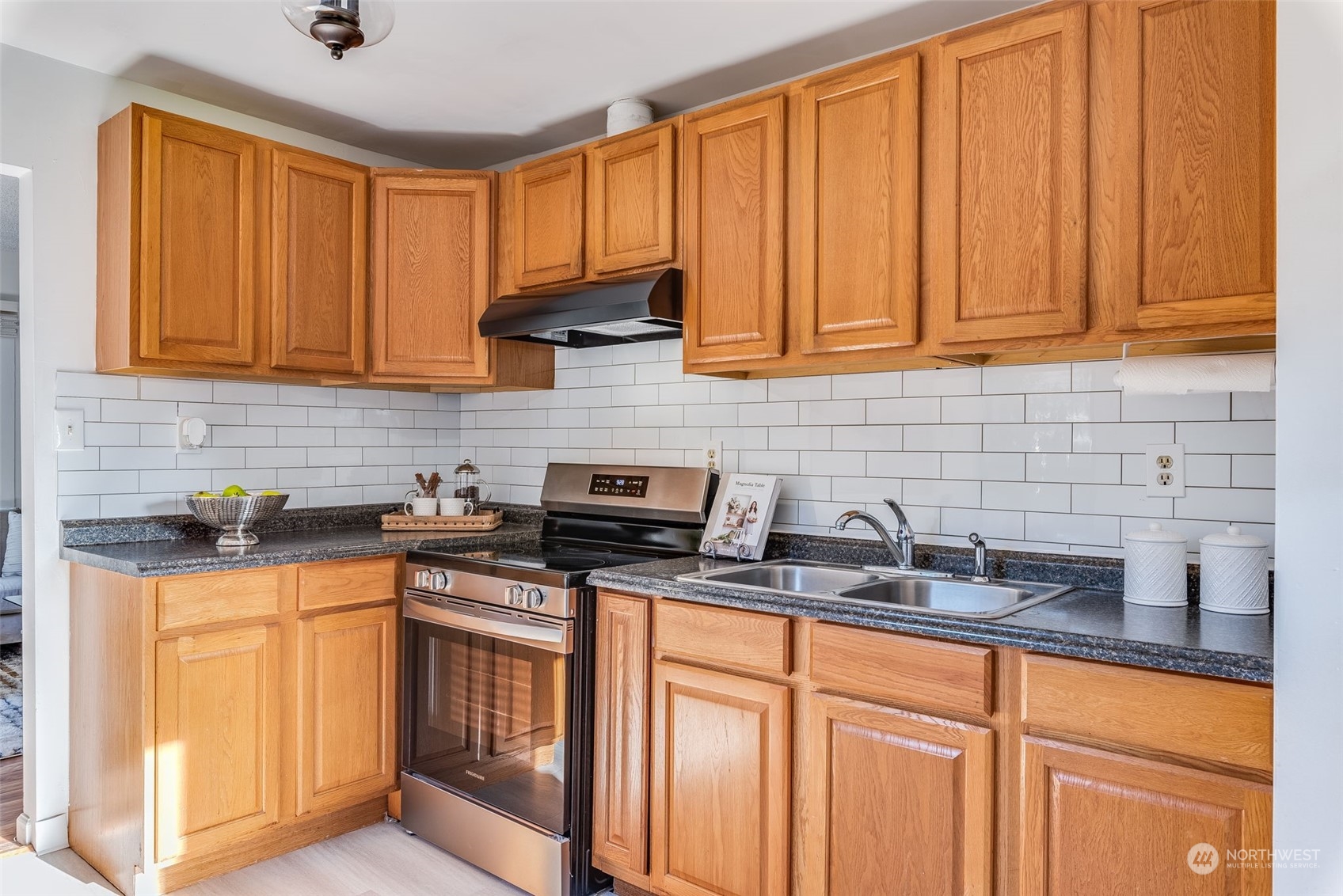 3617 Northeast 12th Street Renton, WA 98056 - Photo 10 of 33 a kitchen with stainless steel appliances granite countertop a sink stove and cabinets