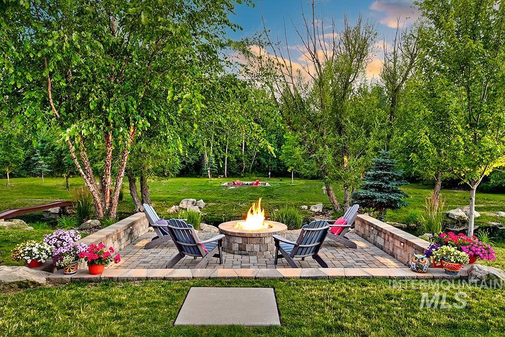 1582 East Rivers End Court Eagle, ID 83616 - Photo 4 of 49 View of grassy yard with an outdoor fire pit and a patio
