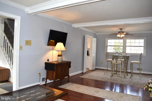 a view of living room with kitchen island furniture and wooden floor