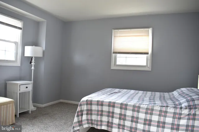 a bedroom with a bed and a lamp