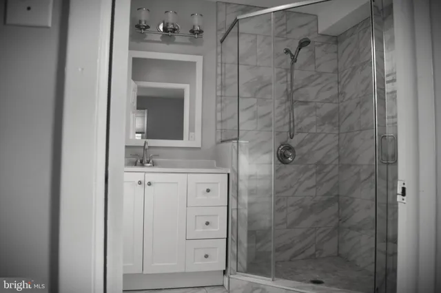 a bathroom with a shower and a sink