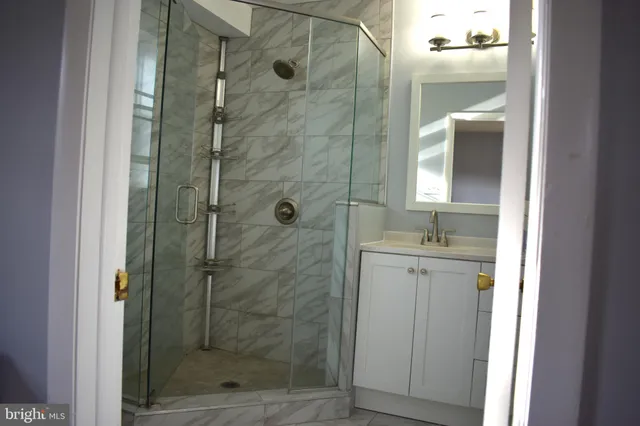 a bathroom with a shower and a sink