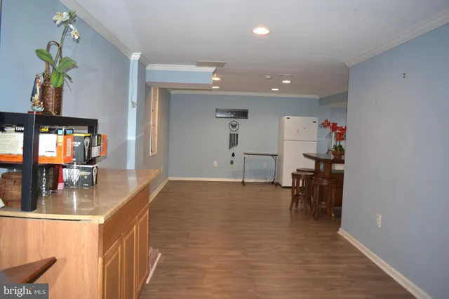 a view of a room with furniture and wooden floor