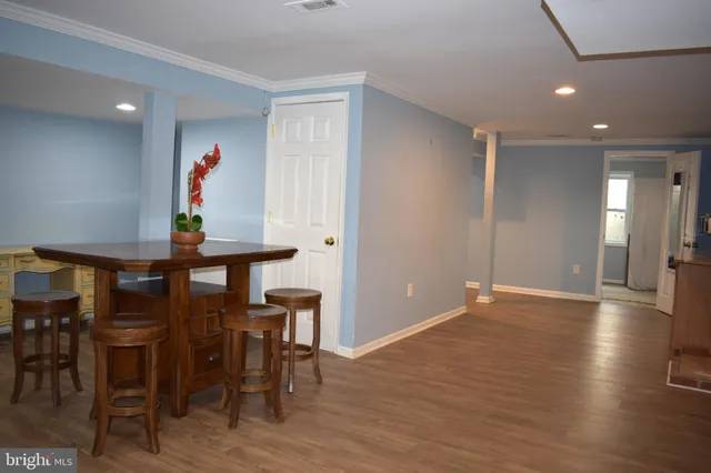 a view of a room with furniture and wooden floor
