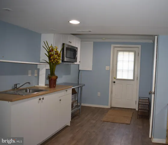 a kitchen with a sink and a refrigerator