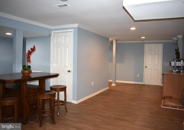 a view of workspace with furniture and wooden floor