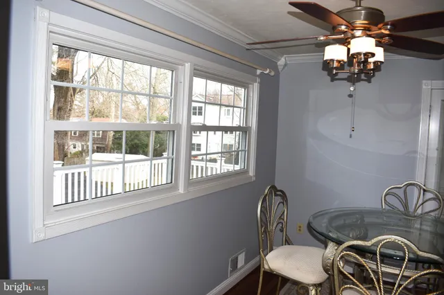 a dining room with furniture a chandelier and window