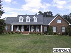 2704 Farmlake Lane Fort Mill, SC 29708 - Photo 1 of 8 a front view of a brick building with a yard
