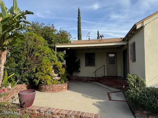 a front view of a house with chairs