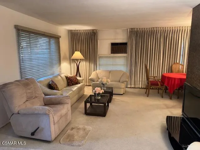 a living room with furniture and a lamp