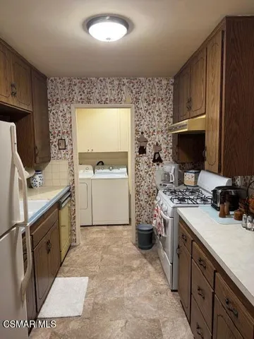 a kitchen with a sink stove and refrigerator