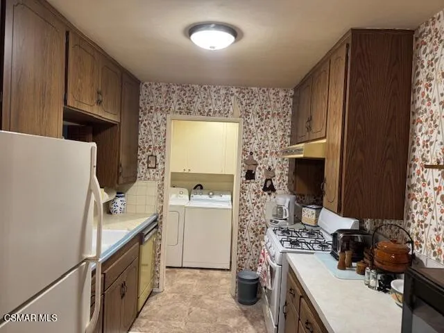 a room with a sink a stove and a refrigerator
