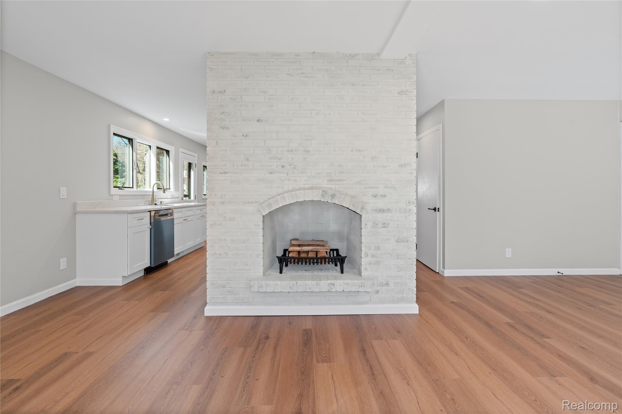 6273 Cold Spring Trail Grand Blanc, MI 48439 - Photo 22 of 48 Unfurnished family room with a fireplace and light wood-type flooring