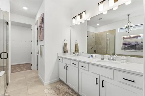 a spacious bathroom with a double vanity sink mirror double and shower