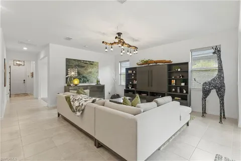 a living room with furniture and a chandelier