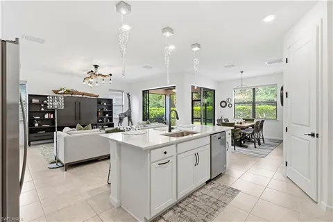 a kitchen with a sink and living room view