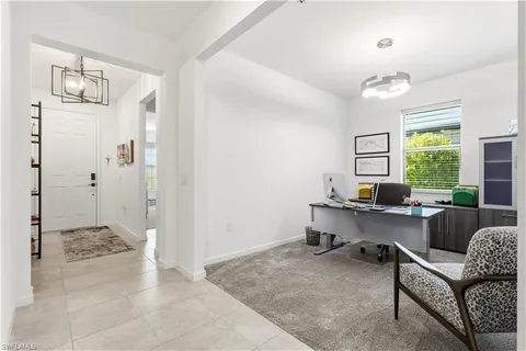 a view of a livingroom with workspace and a window