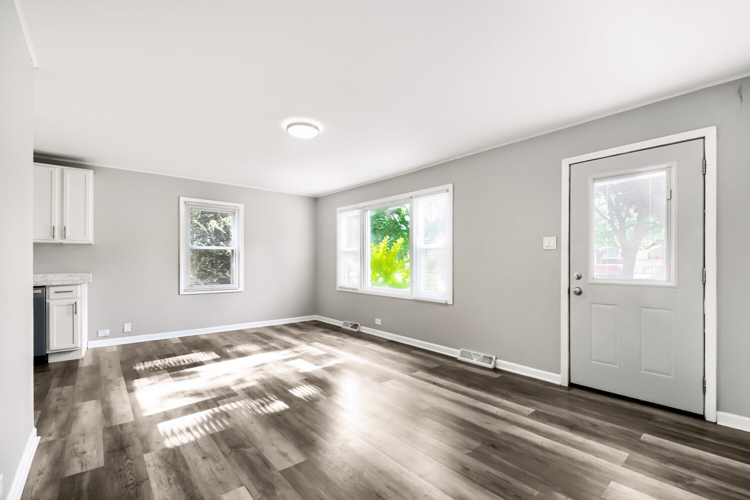 15013 Springfield Avenue Midlothian, IL 60445 - Photo 4 of 17 a view of empty room with window and wooden floor