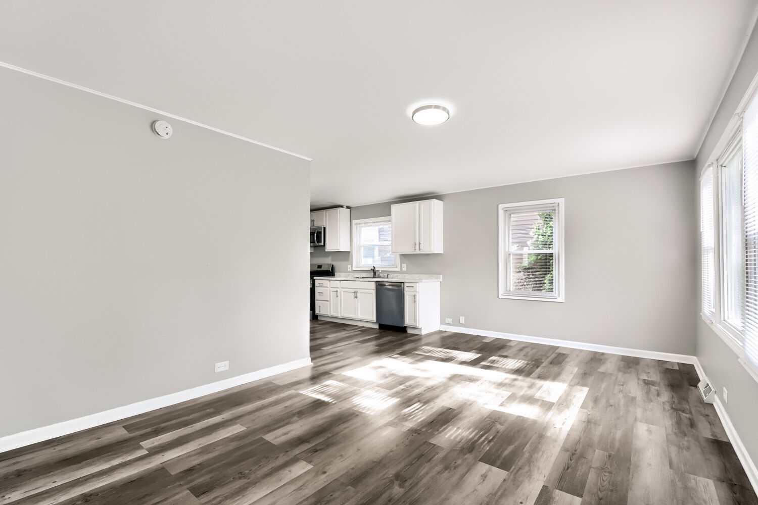 15013 Springfield Avenue Midlothian, IL 60445 - Photo 6 of 17 a view of a kitchen with wooden floor and a window