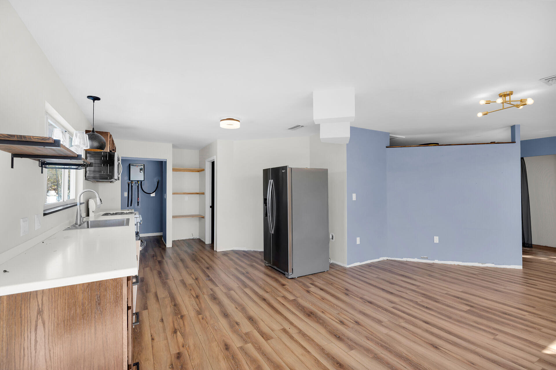 100 Point Pleasant Drive Key Largo, FL 33037 - Photo 12 of 32 a view of a kitchen with wooden floor and a refrigerator
